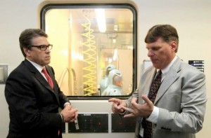 Tom Geisbert, right, a professor of Microbiology and Immunology at the University of Texas Medical Branch, explains to Texas Gov. Rick Perry the work researchers are conducting in a Bio Safety Level 4 lab in the Galveston National Laboratory on Tuesday, Oct. 7, 2014. Perry and other state officials toured the national laboratory a day after he created a Task Force on Infectious Disease Preparedness and Response. (AP Photo/The Daily News, Jennifer Reynolds, Pool) 